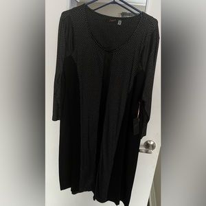 Black long sleeve dress with tiny polka dot panels and faux leather details.